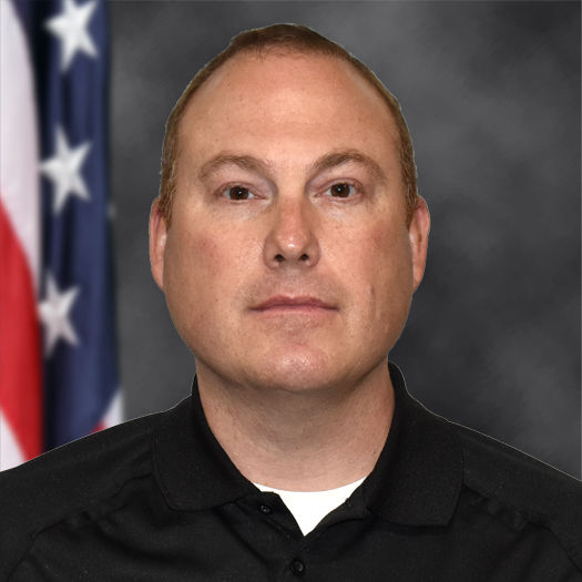 Man in black shirt with US flag background